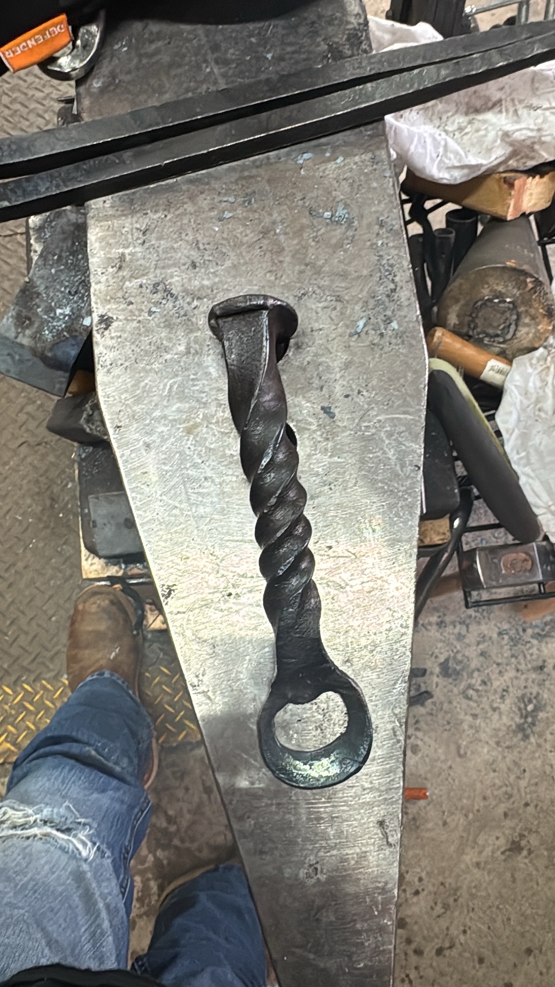 Twisted forged bottle opener on an anvil